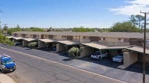 a parking lot with cars parked under an overpass