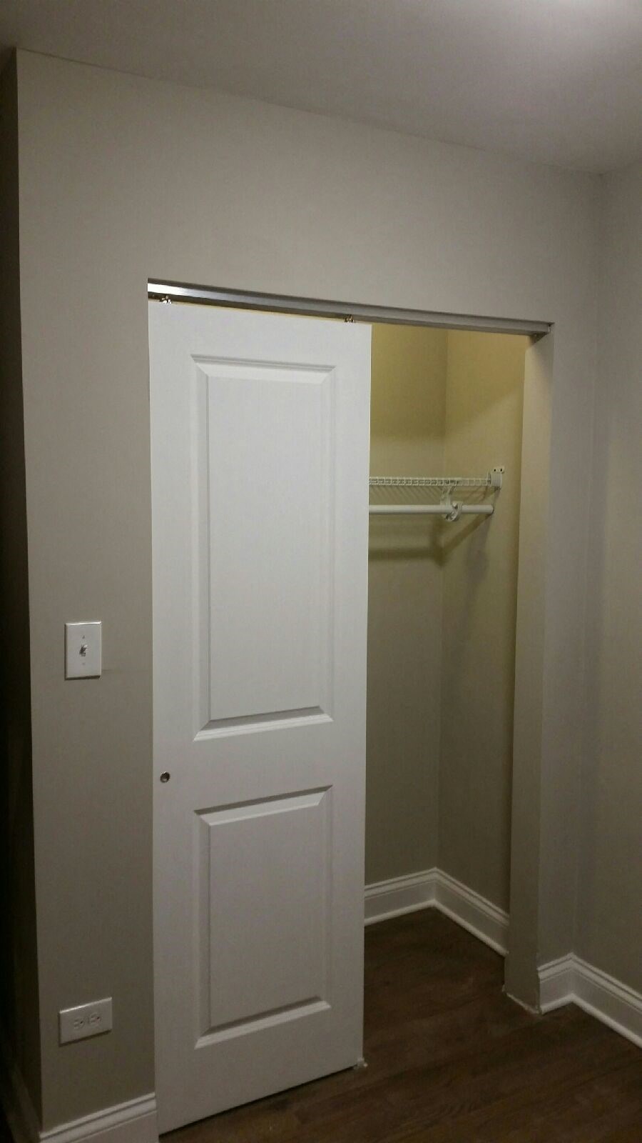 a closet with a white door and a white closet door