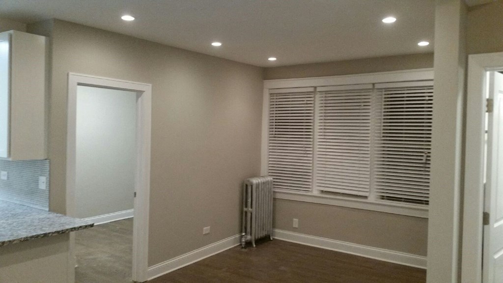 a living room with a large window and a door to a closet
