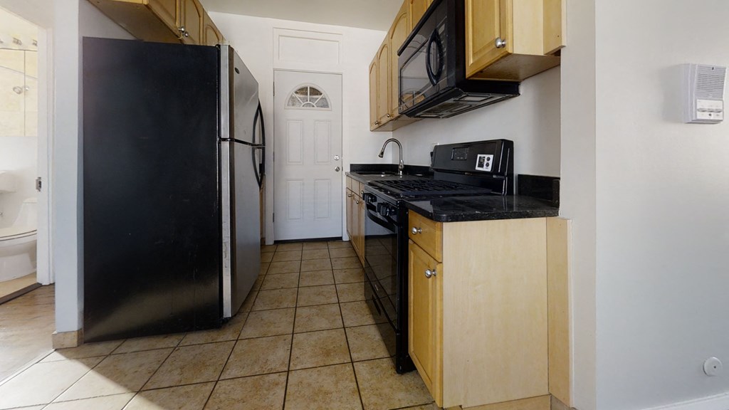 a kitchen with a stove refrigerator and a sink