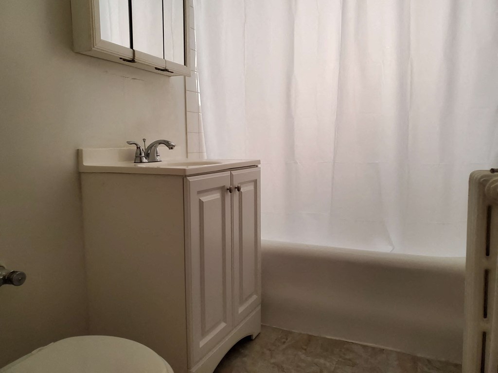 a small bathroom with a sink and a bath tub