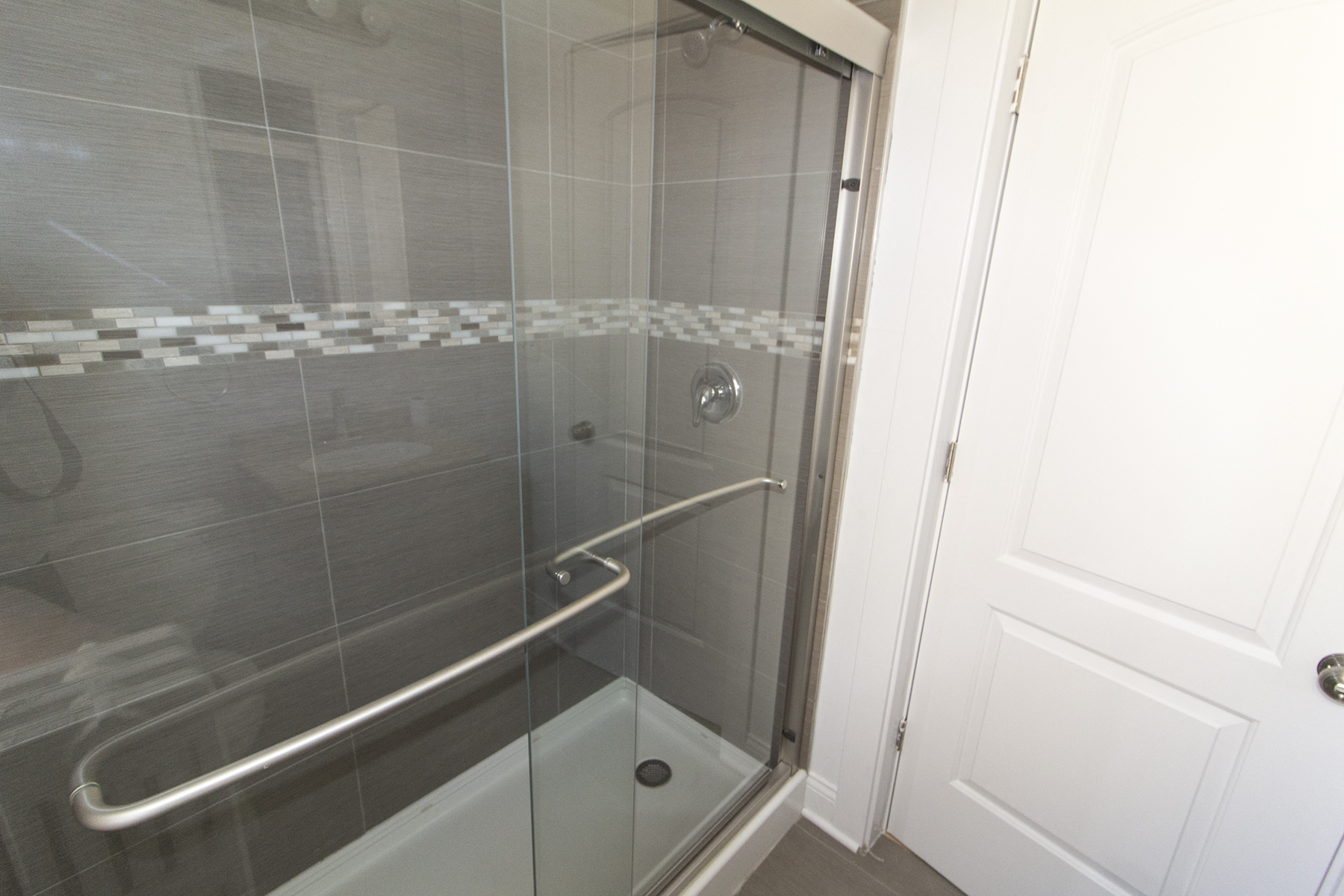 a shower in a bathroom with a glass door
