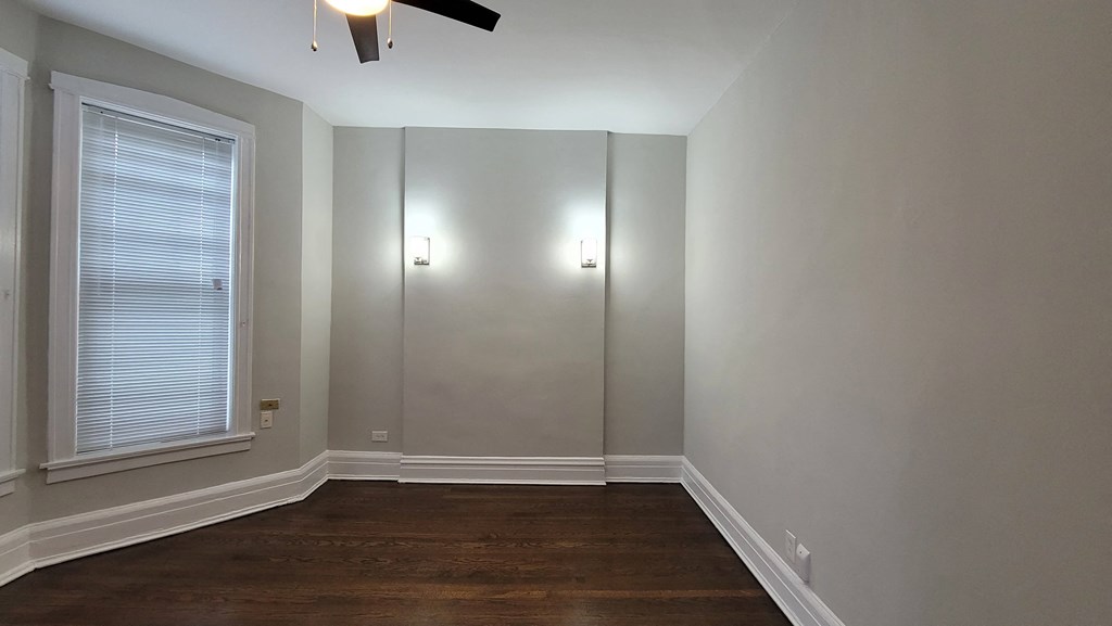 a room with a large window and a hard wood floor