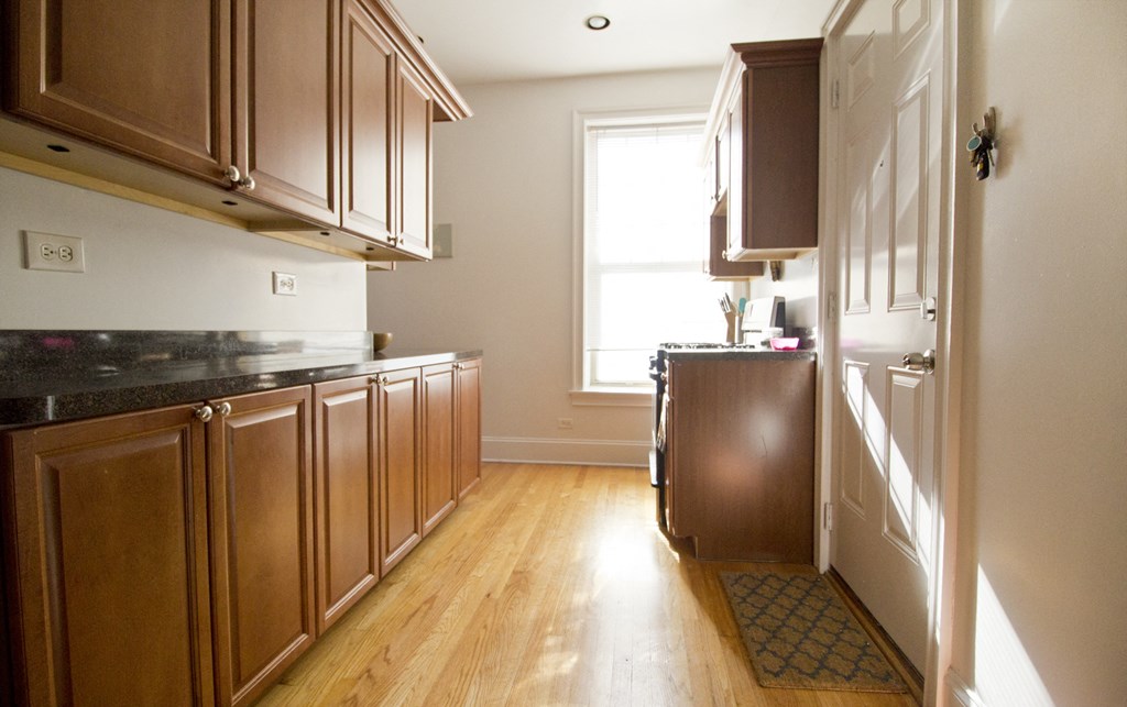 a kitchen with wooden cabinets and a window