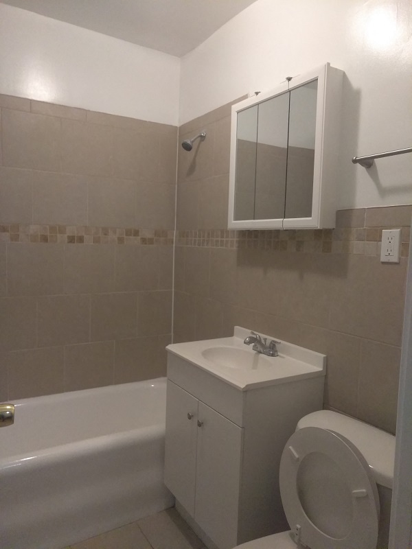 a bathroom with a sink toilet and a bath tub