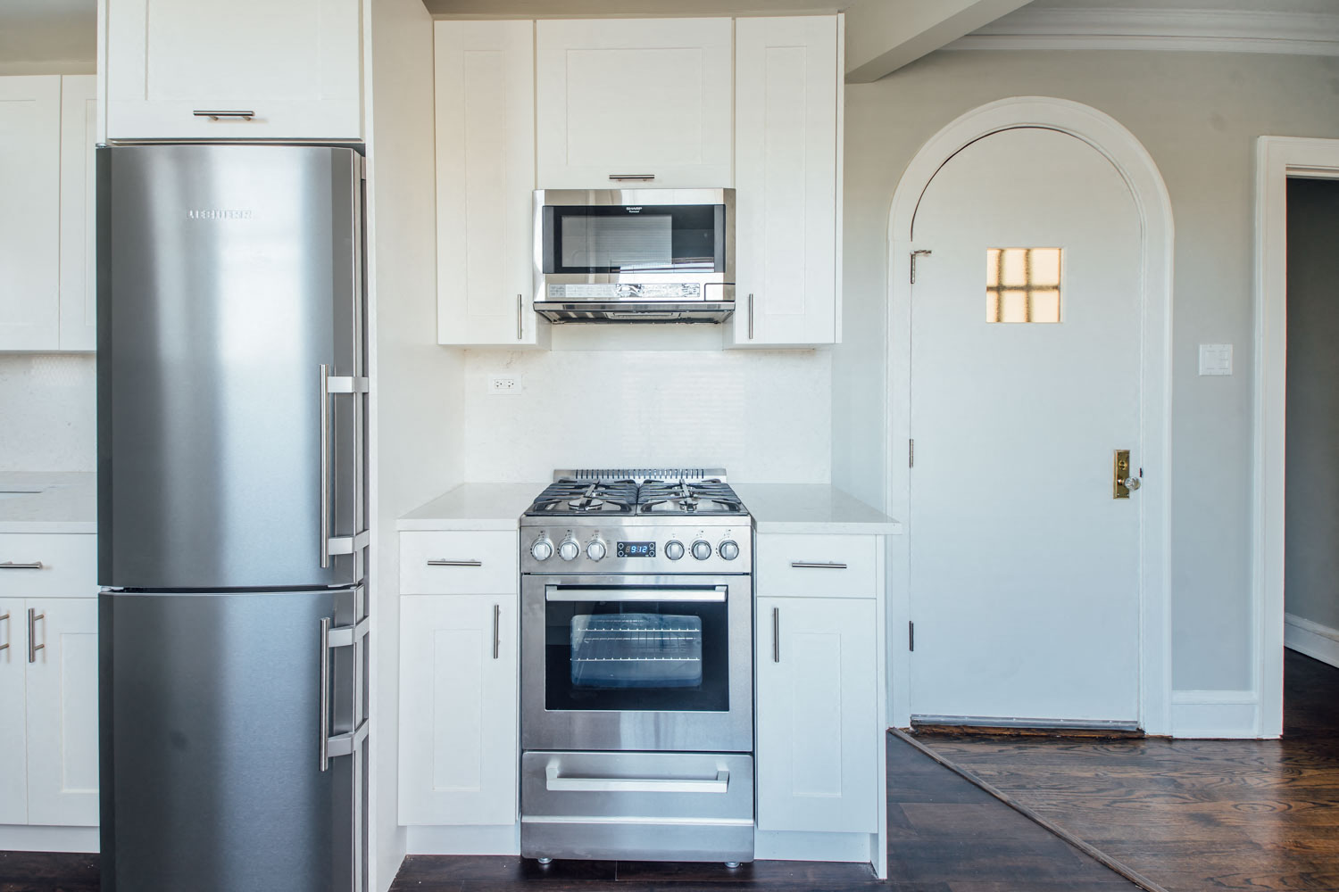 a kitchen with stainless steel appliances and white cabinets