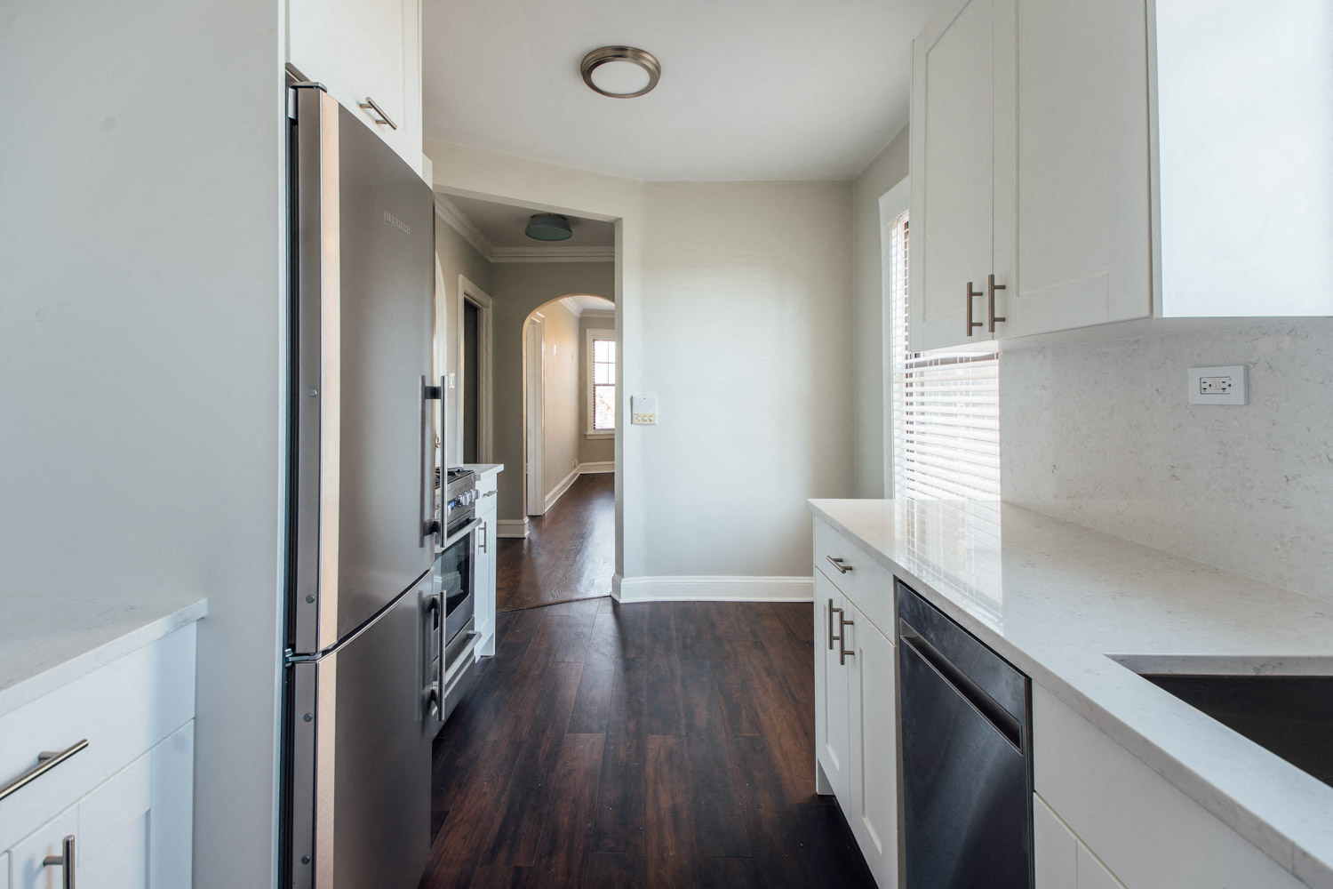 a kitchen with white cabinets and stainless steel appliances
