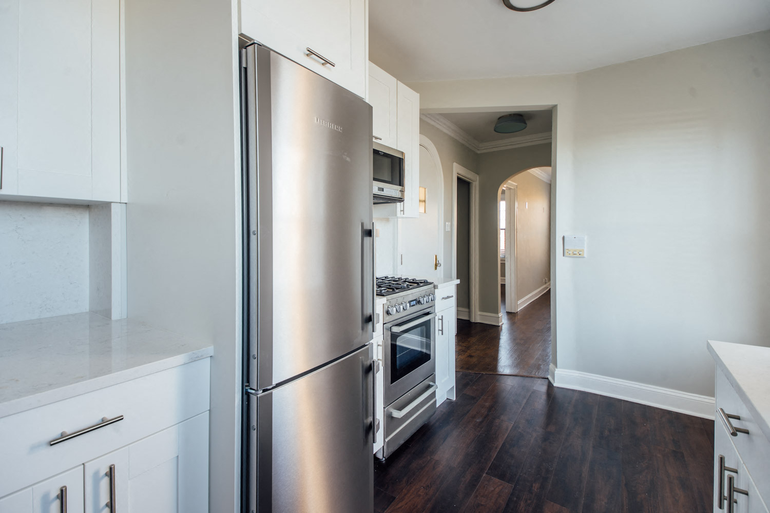 a kitchen with stainless steel appliances and white cabinets