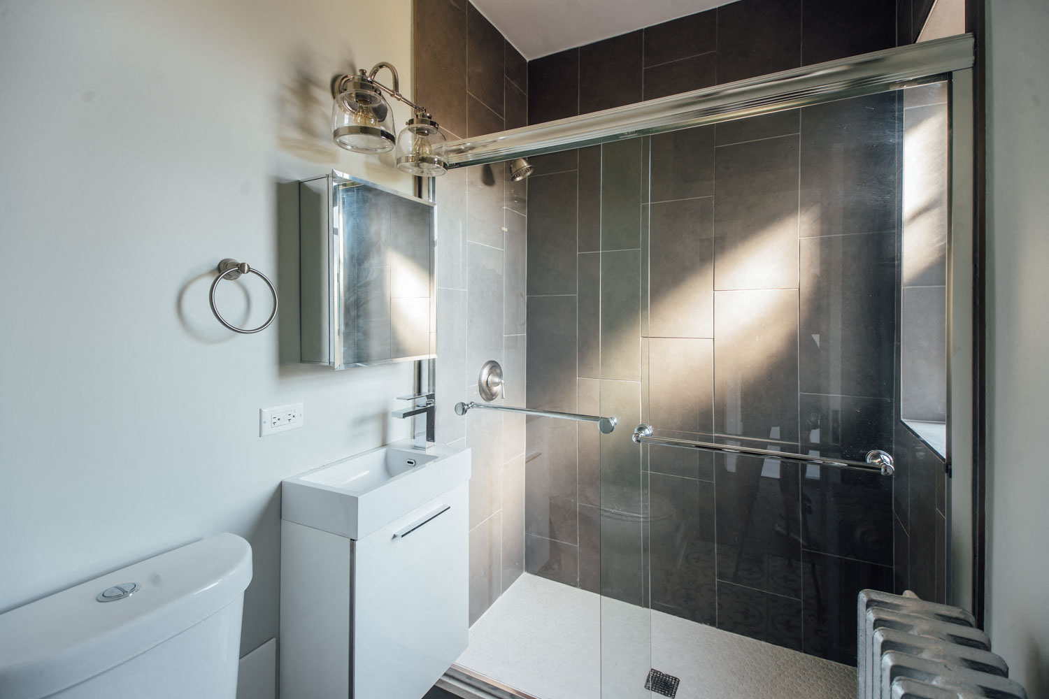 a black and white bathroom with a shower and a toilet