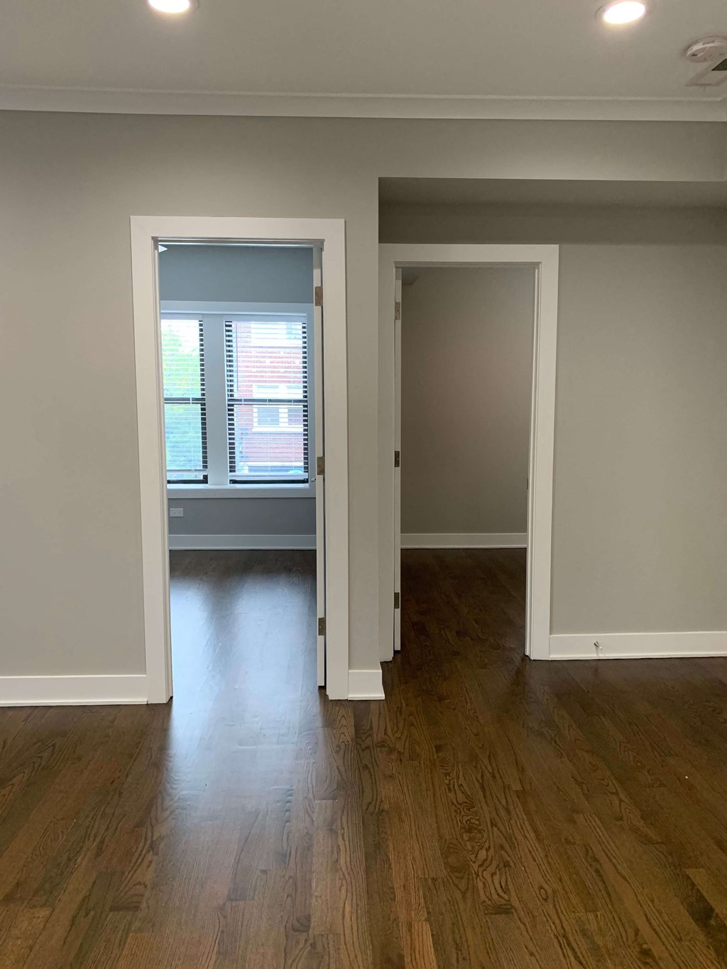 a living room with a hard wood floor and a window