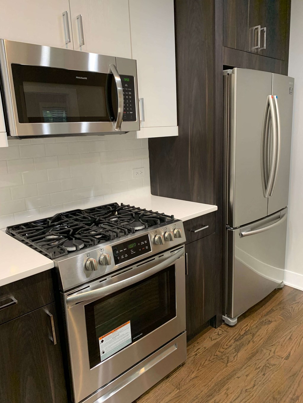 a kitchen with stainless steel appliances and a refrigerator