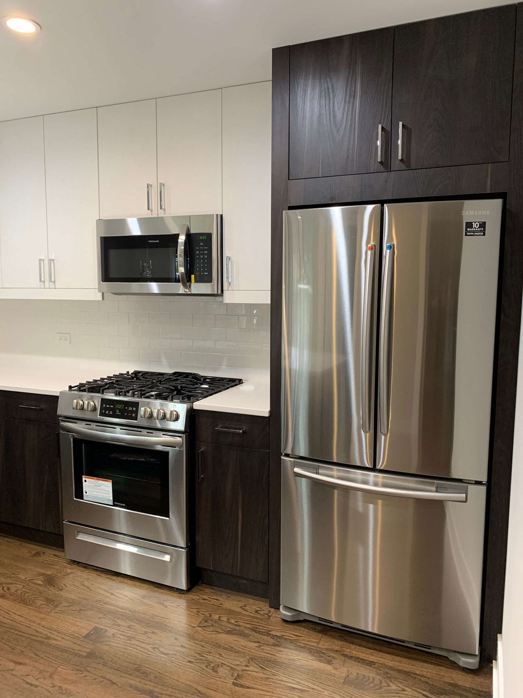 a kitchen with stainless steel appliances and white cabinets