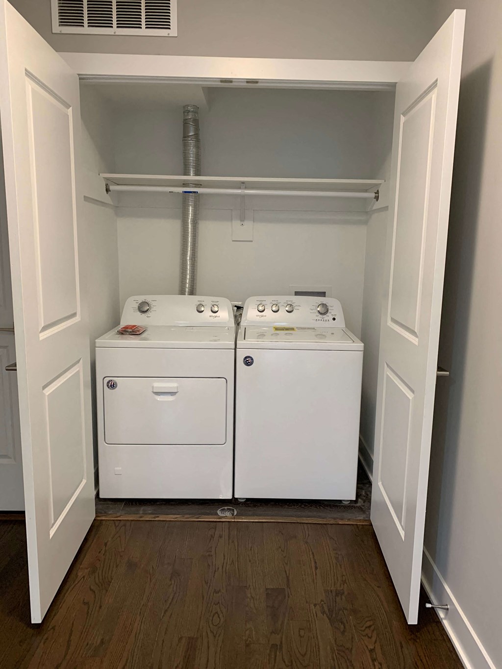 a washer and dryer in a room with white doors