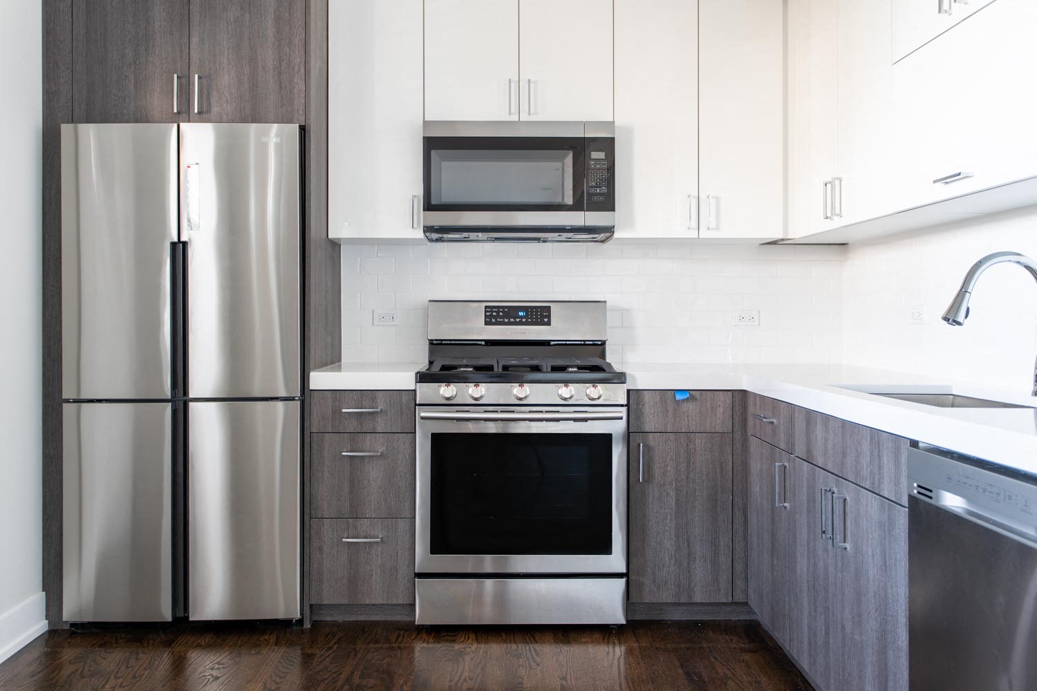 a kitchen with stainless steel appliances and white cabinets