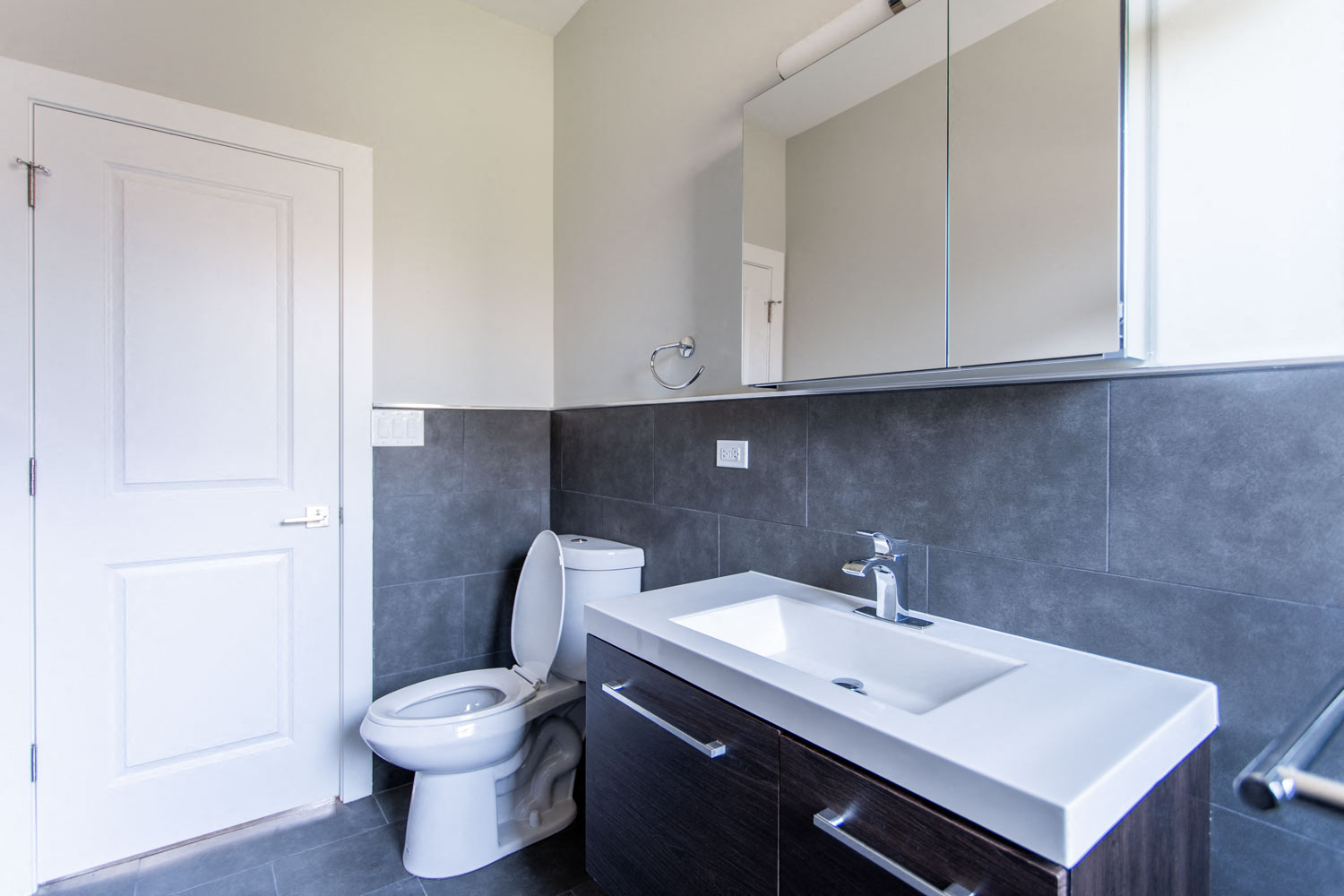 a bathroom with a toilet and a sink and a mirror