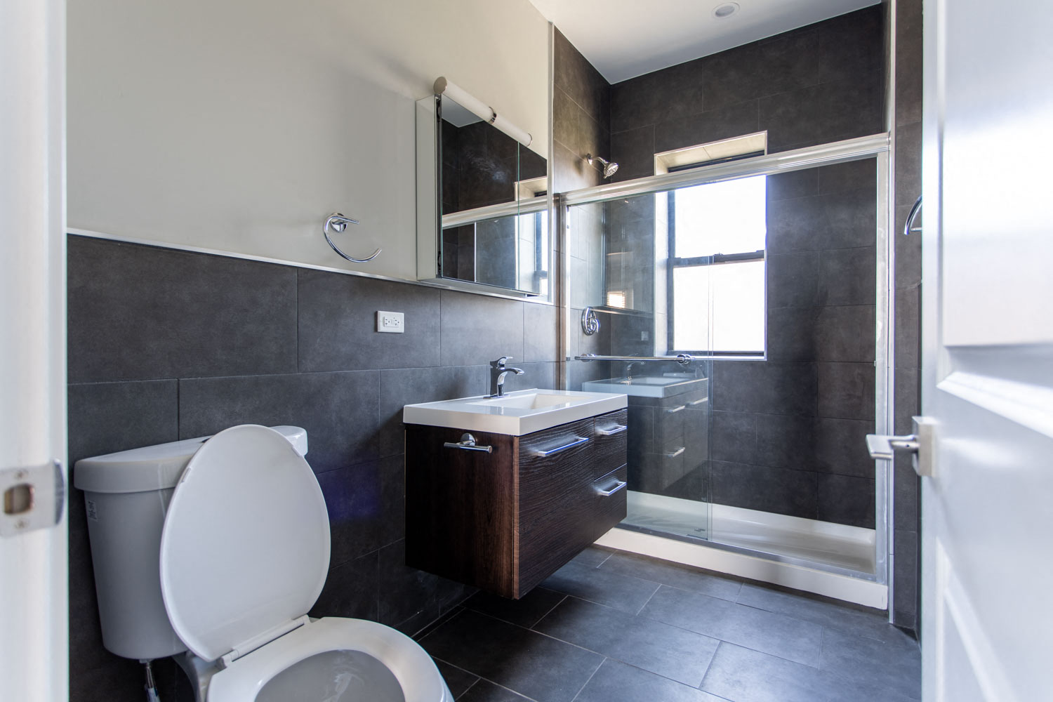 a bathroom with a toilet and a sink and a shower