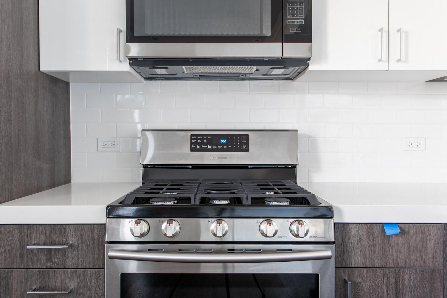 a kitchen with a stove and a microwave