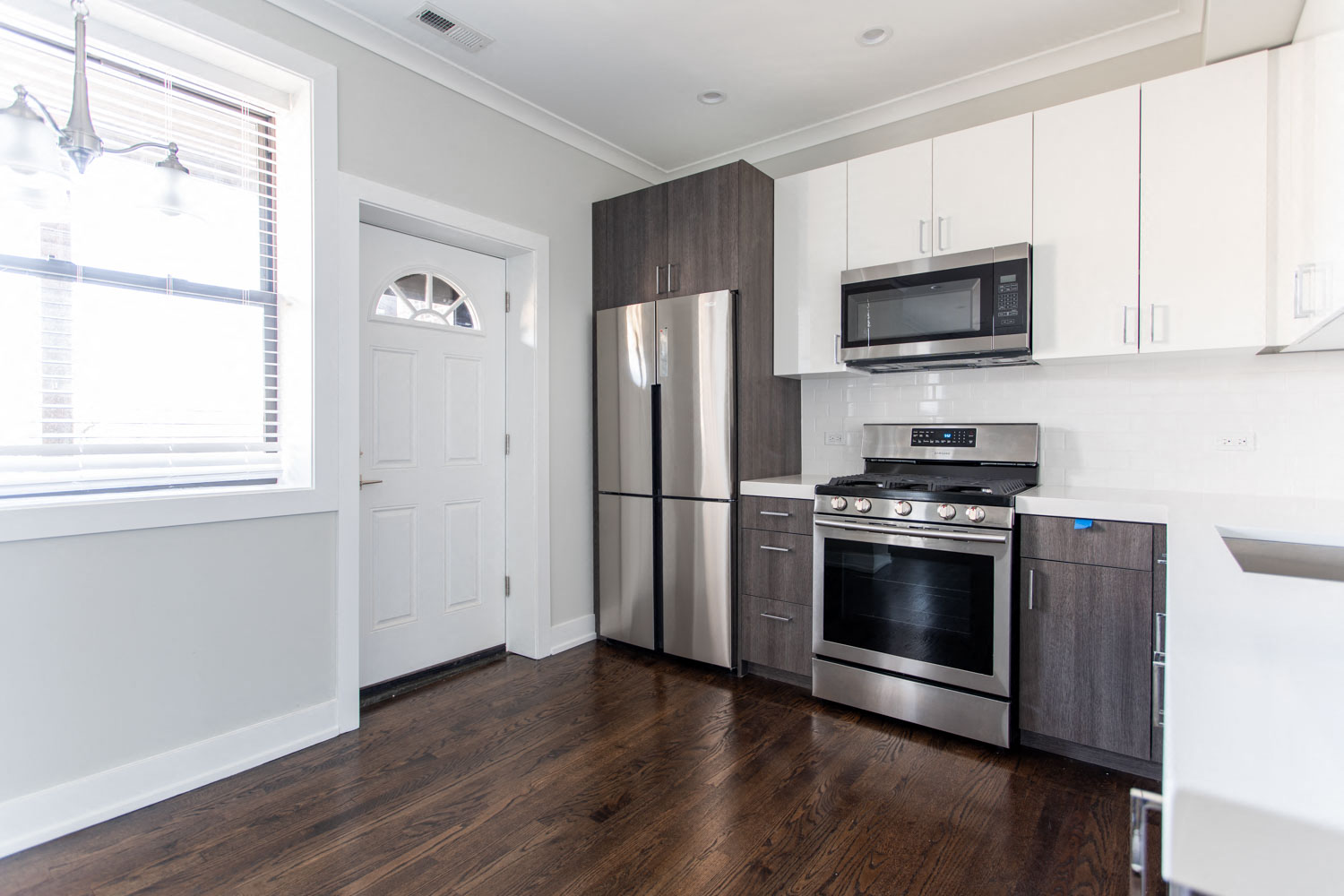 a kitchen with stainless steel appliances and white cabinets