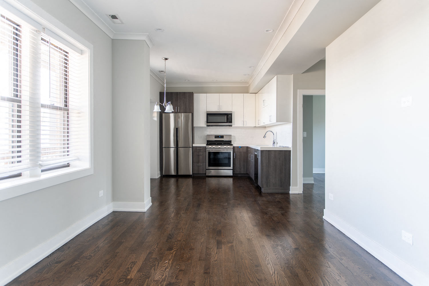 an empty kitchen with a large window and