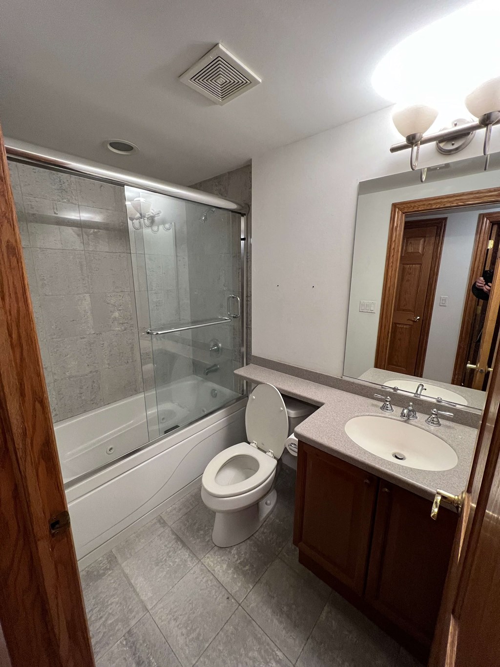 a bathroom with a toilet and a sink and a shower