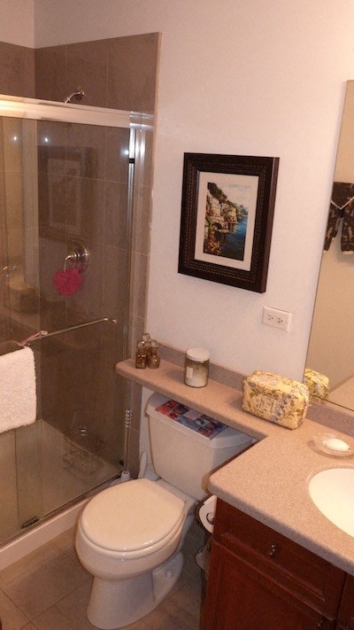 a bathroom with a toilet and a shower