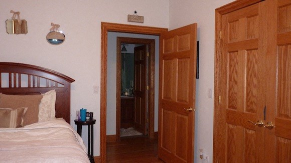 a bedroom with a bed and two wooden doors