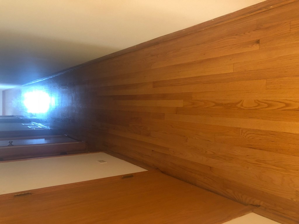a wall with wood paneling in a room
