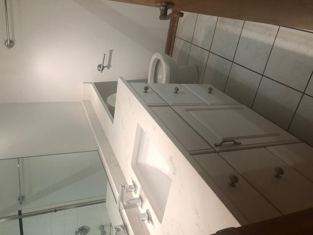 a bathroom with a sink and a toilet and a mirror