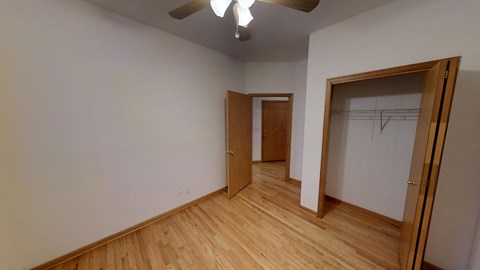 a bedroom with a closet and a door to a hallway