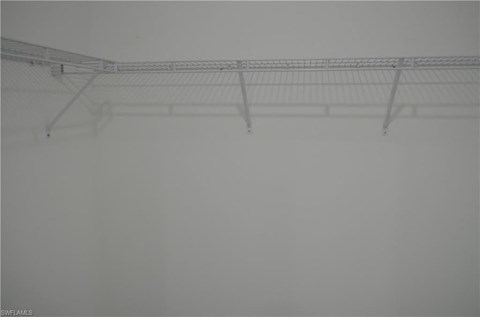 a foggy room with a wire rack on the ceiling