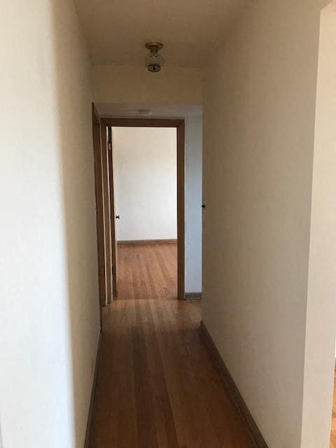a hallway with a wood floor and a door