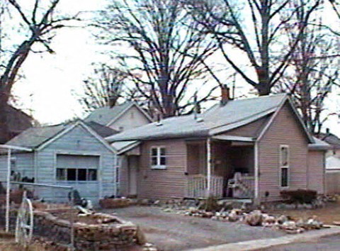 a pink house with a yard in front of it