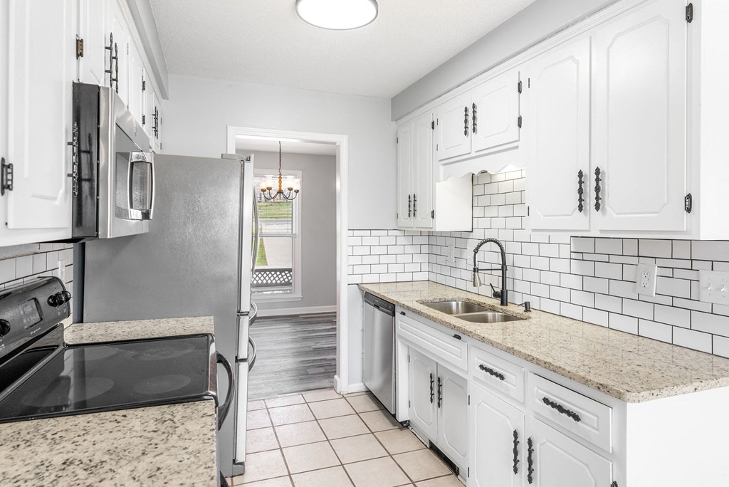 a kitchen with white cabinets and a sink