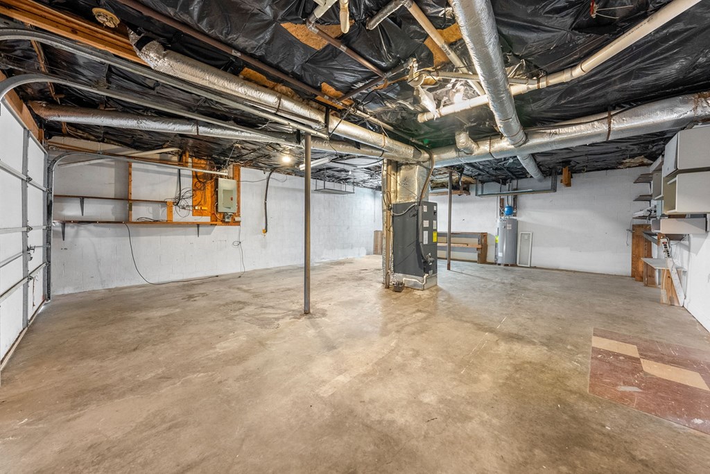 a large room with concrete floors and pipes in it