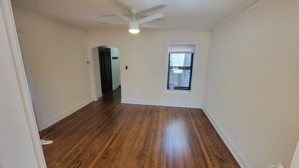 a living room with a ceiling fan and a window