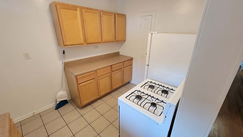 a kitchen with a stove and a refrigerator