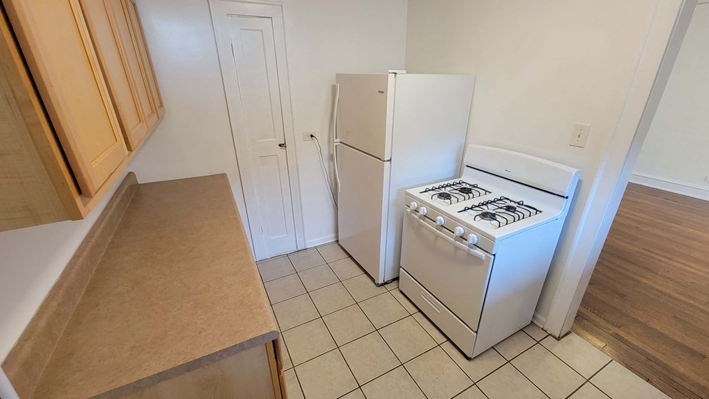 a kitchen with a stove and a refrigerator