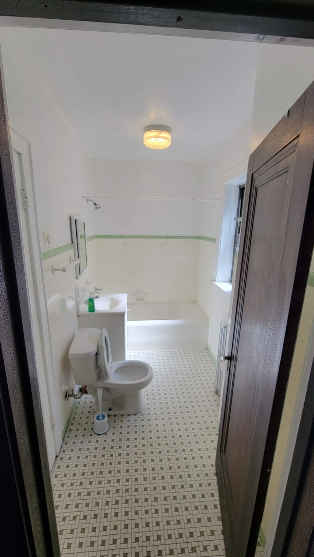a small bathroom with a toilet and a bath tub