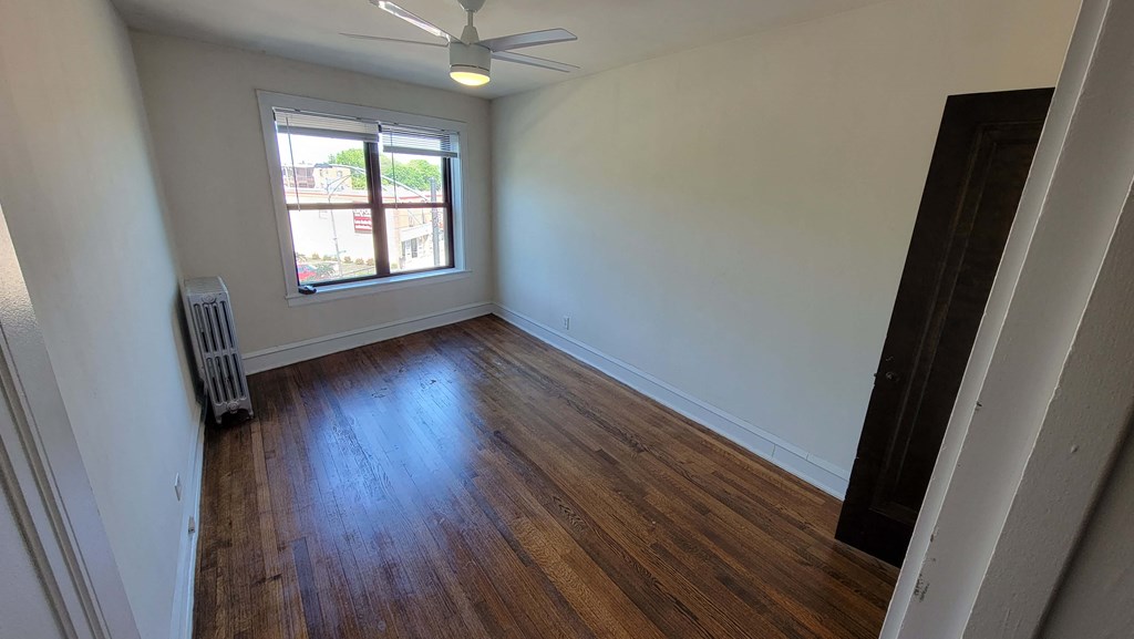 a living room with wood floors and a window