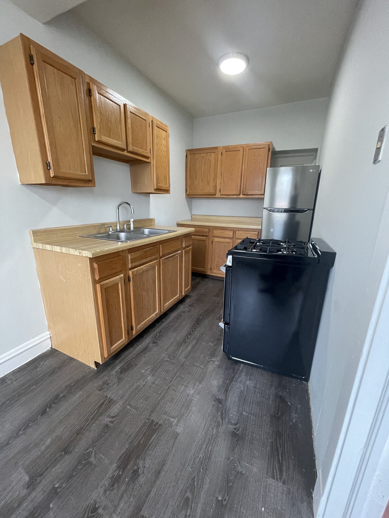 a kitchen with wooden cabinets and a stove and a sink