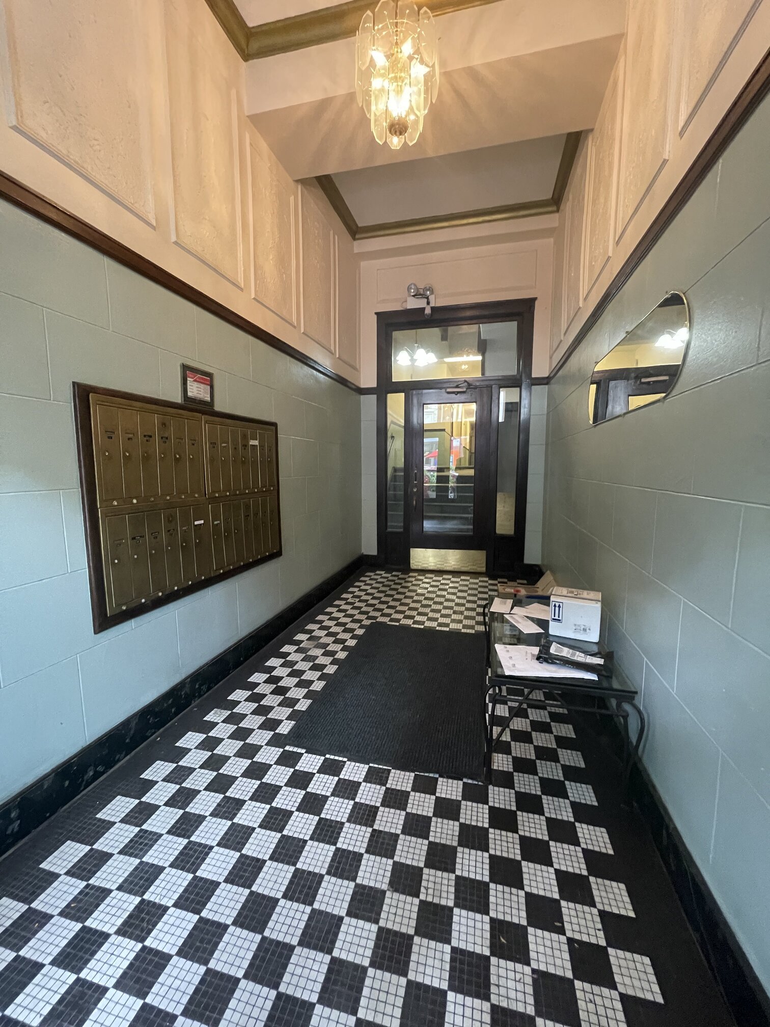 a hallway with a black and white checkered floor and a door