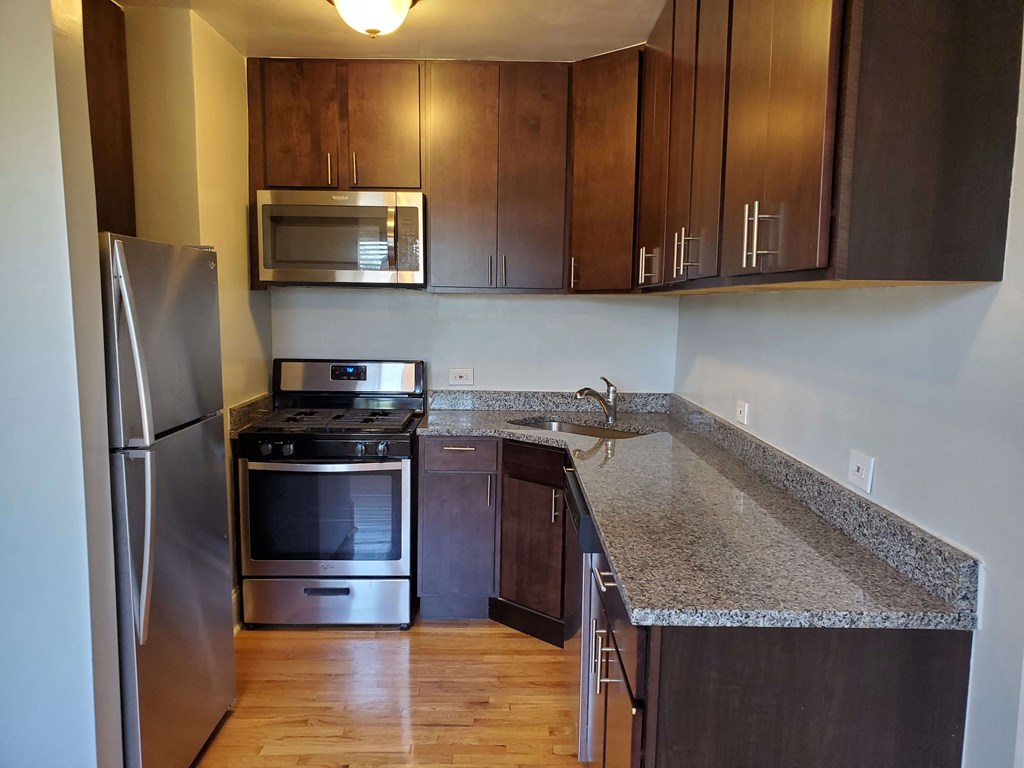 a kitchen with a granite counter top and stainless steel appliances