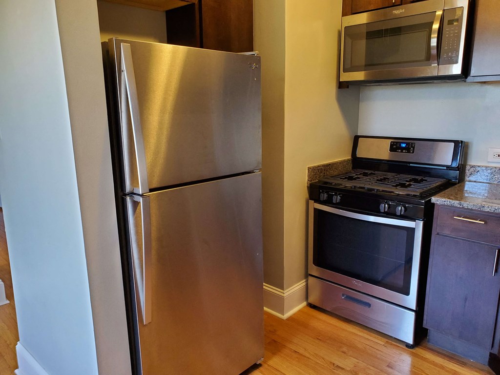 a kitchen with a stainless steel refrigerator and stove