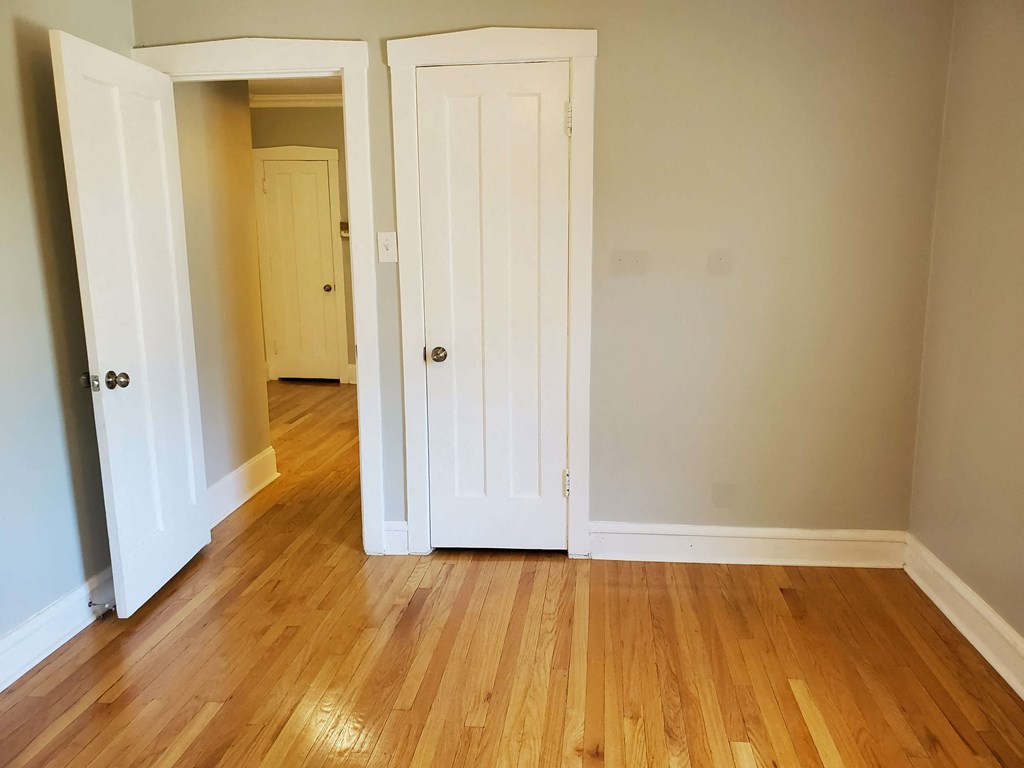 a room with a hard wood floor and two doors