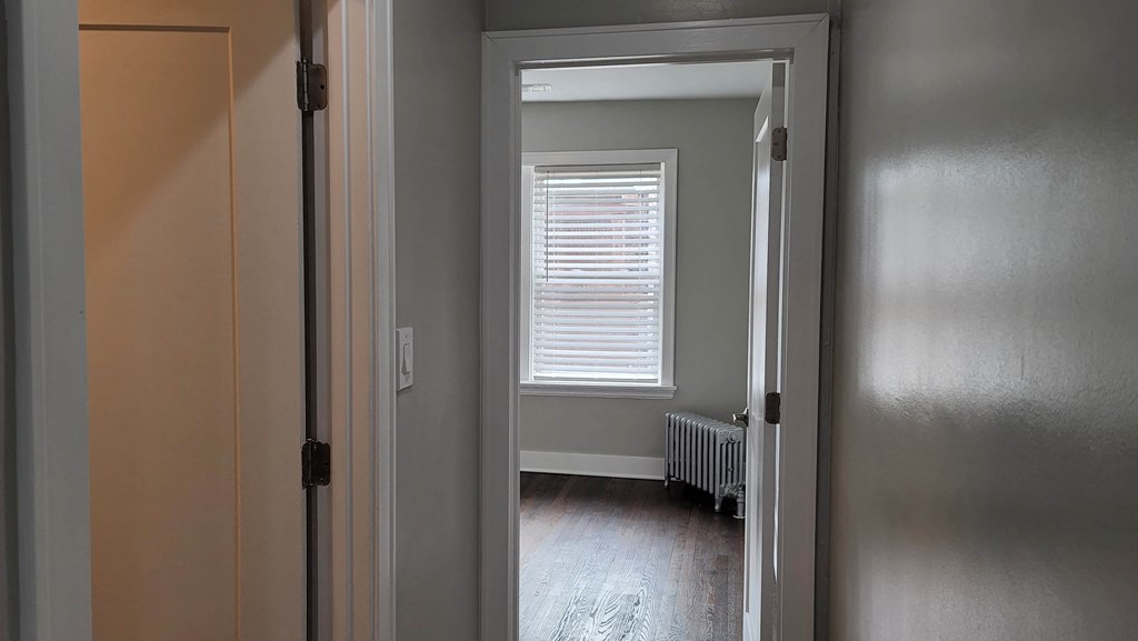 a room with a radiator and a window and a door