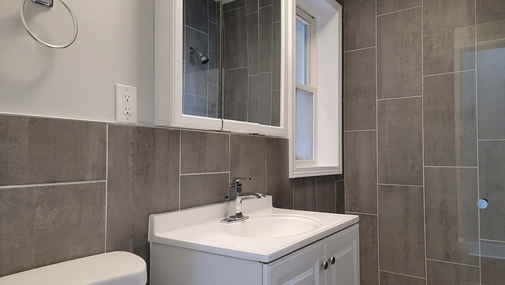 a small bathroom with a sink and a mirror