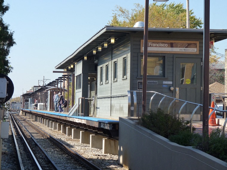 a train station with a train on the tracks