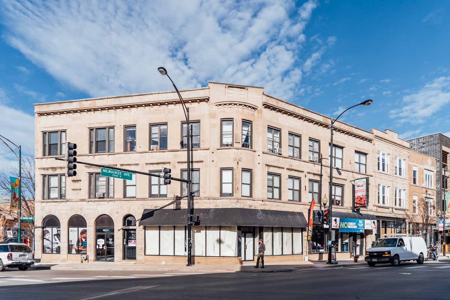 a large building on the corner of a city street