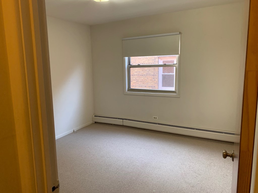 an empty room with a window and a door