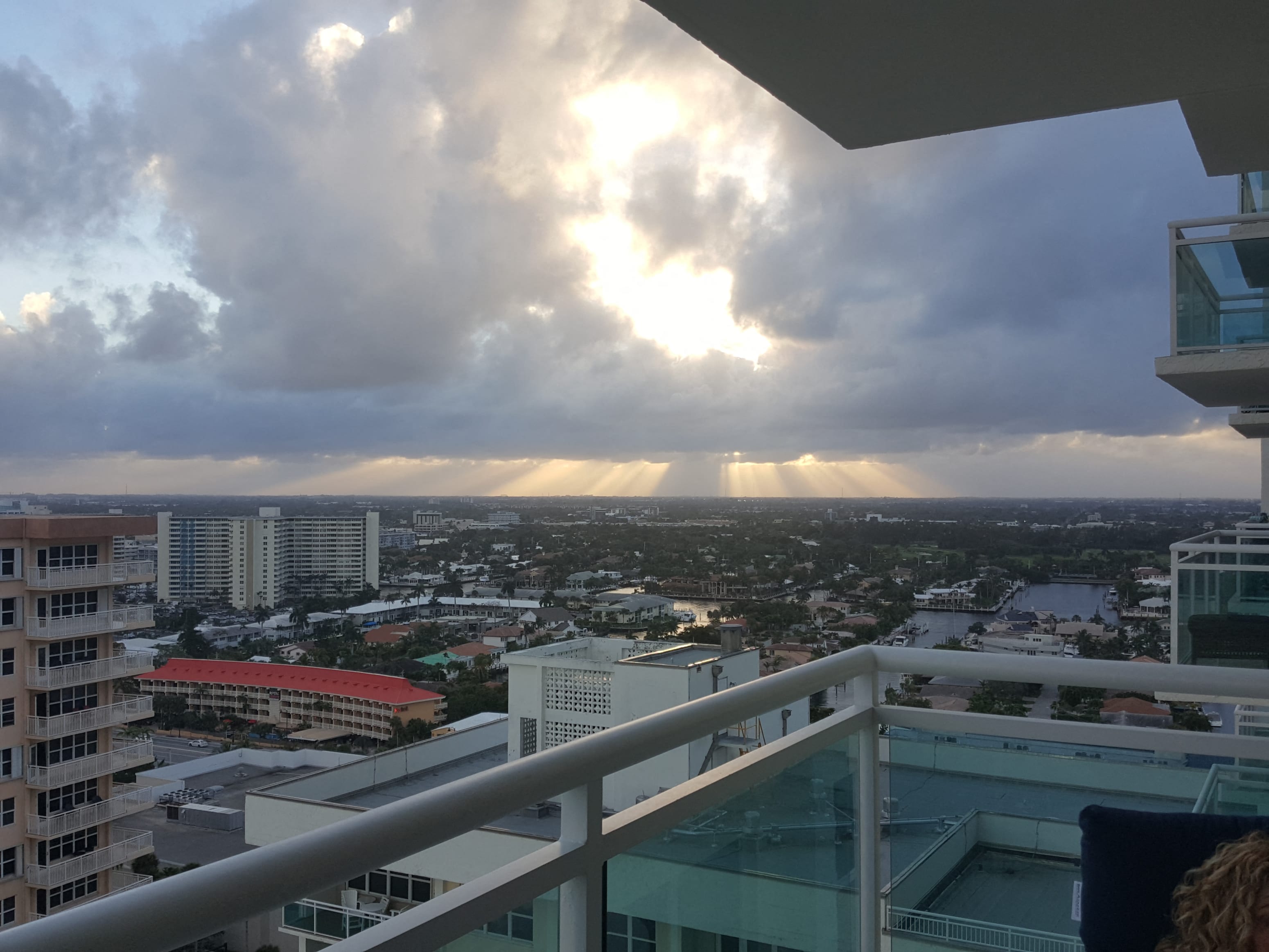A cityscape with buildings and a cloudy sky.